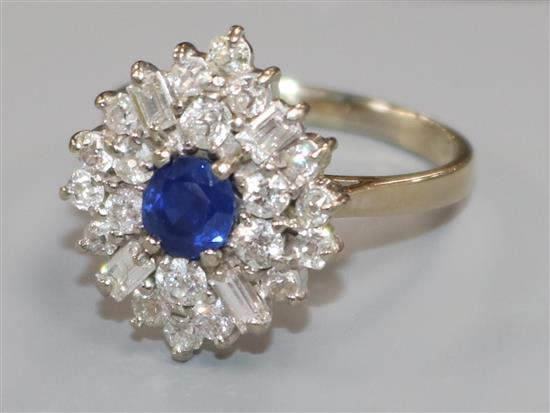 An 18ct white gold, sapphire and diamond cluster dress ring, set with baguette and round cut diamonds, size T